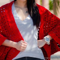 a woman wearing a red knitted cardigan