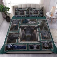 a bed covered in a green blanket with pictures of cows on it's sides