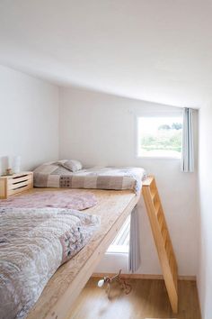 there is a bunk bed in the corner of this room with a ladder leading up to it