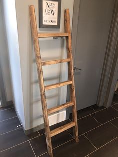 an old wooden ladder leaning against the wall