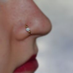 a woman's nose with a tiny white stone in the middle