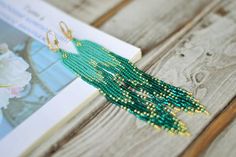 Extra long beaded fringe earrings, Turquoise emerald green gold tassel seed beaded earringsWhole length : 5.8" (14.5 cm)❤ CUSTOM ORDERSIt is ABSOLUTELY HANDMADE . So if you like this item in a different color or size, send me a message please. I will send you a link for a "custom order" and you'll be able to place the order there. Please feel free to communicate with me.SHIPPINGItem will be shipped carefully packed in a GIFT BAG!! Shipping cost includes tracking number!-If item is ready to ship Elegant Green Beaded Earrings With Gold Beads, Turquoise Beaded Earrings With Tassels For Gift, Green Fringe Dangle Jewelry, Green Beaded Fringe Jewelry For Party, Bohemian Green Earrings With Gold Beads, Elegant Green Beaded Fringe Tassel Earrings, Elegant Green Beaded Earrings With Tassels, Elegant Green Tassel Earrings With Fringe, Bohemian Green Jewelry With Beaded Fringe