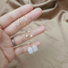 These Jade long dangle earrings/White jade flower earrings/Lily of the valley earrings/Flower dangle earrings/White Jade earrings are so cute to wear. They are made with white jade flower beads and tiny freshwater pearls (3.5-4mm). The earrings are approximately 2 inches long. They look elegant and beautiful on you.  They will be a wonderful gift for yourself or your loved one. Due to hygiene reasons, earrings are not returnable or exchangeable. All purchases above $35 will be shipped through US Dainty White Dangle Flower Earrings, Delicate White Dangle Crystal Earrings, Delicate White Crystal Earrings For Gift, White Crystal Dangle Earrings, Delicate White Crystal Earrings, White Earrings With Dangling Charms For Gift, Dainty Pearl Drop Dangle Flower Earrings, Minimalist White Crystal Drop Earrings, Dainty White Linear Earrings For Gift