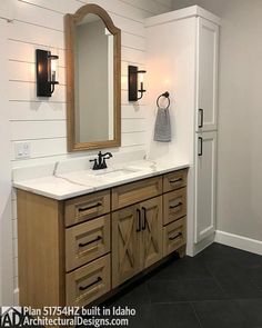 a bathroom with two sinks and a large mirror