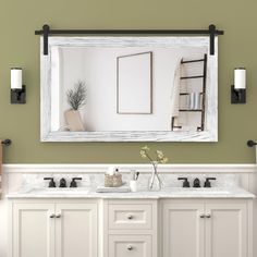 a bathroom vanity with two sinks and a large mirror above it, in front of a green wall