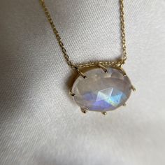 A simple rose-cut rainbow moonstone pendant that refracts the light to show the rainbow of colours that this gemstone possess. Watch the colours dance in the light and what colours will you see? Pair with a delicate chain or our very own Erica necklace for the perfect layering look. Crafted in 18ct Vermeil 16" chain with 2" extender Gemstone 16 x 12mm Moonstone: Stone of New Beginnings  Moonstone is a stone for inner growth and strength. It promotes inspiration, enhances intuition and good fortu Iridescent Moonstone Gemstone Necklaces, Iridescent Moonstone Gemstone Necklace, Ethereal Gemstone Necklace For Gift, Iridescent Oval Gemstone Necklaces, Iridescent Oval Gemstone Necklace, Ethereal Oval Jewelry For Gifts, Inner Growth, Simple Rose, Rainbow Moonstone Pendant