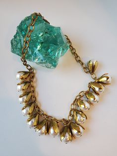 "Stunning 1940's  vintage pearl  tear drop encased in brass and gold chain necklace. We love how stunning this bib necklace lay's on the neck. This gorgeous necklace is gold toned and has 15 pearls hanging from the chain. This vintage necklace is gorgeous and is perfect for any fan of mid century fashion! Perfect for both vintage-inspired looks and contemporary fashion! Get this necklace for yourself or for someone in your life who loves vintage fashion! Excellent vintage condition  Necklace Length 18\" Pearl drop 9\" US SHIPPING  FREE International shipping, please see the rate Please add our shop as a ❤ favorite so you can find us again!   Our website is minxandonyx.com Www.facebook.com/minxandonyx @minxandonyx follow us on Instagram Thank you for shopping at Minx and Onyx Vintage!" Vintage Gold Pearl Necklace With Pearl Drop, Vintage Pearl Drop Jewelry For Vintage Events, Vintage Metal Necklace With Pearl Charm, Vintage Gold Pearl Drop Necklace, Vintage Drop Necklace For Formal Occasions, Vintage Pearl Jewelry With Vintage Charm, Vintage Drop Necklaces For Wedding, Vintage Pearl Necklace With Metal Pearl Charm, Vintage Metal Pearl Necklace As Gift