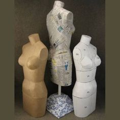 three wooden mannequins made out of newspaper