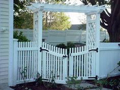 a white picket fence with a gate in the middle