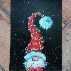 a painting of a santa clause hat with pom - poms on it's head