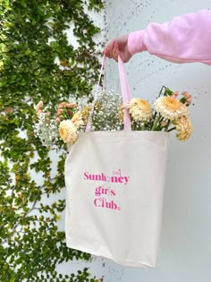 Join The Sunhoney Girls Club with our newest tote bag! This tote features classic canvas material, pink straps, gusset bottom and hold all the essentials and more! Pairs perfectly with any outfit and perfect for those days when you're on the go! 100% Cotton *Product is Made To Order - ships in 3-4 business days* All accessories are final sale. Pink Cotton Bag For Summer, Pink Cotton Bags For Summer, Pink Canvas Weekend Bag, Weekend Canvas Tote Bag, Canvas Bag For Weekend In Summer, Canvas Bags For Spring Weekend, Canvas Bag For Weekend In Spring, Spring Cotton Canvas Bag With Adjustable Strap, Canvas Bag For Weekend And Spring Season