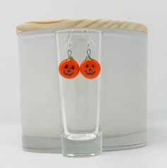 These orange pumpkin earrings will make you smile too.  A green stem tops these orange glass earrings.  Nichrome wire is fused between two layers of glass and polished after fusing.  Each pair of earrings will arrive on a display card in a white organza bag suitable for gifting. *Silverplated and goldplated earrings are hypo-allergenic. *French ball and fish hook earrings come with silicon backs. *Silver leverback earrings are interchangeable. *All earrings come with wires shown unless ordered differently. Fun Orange Jewelry For Gifts, Fun Orange Earrings As A Gift, Fun Orange Earrings For A Gift, Fun Orange Earrings For Gift, Novelty Orange Jewelry For Gift, Orange Wire Wrapped Earrings For Gift, Fun Orange Earrings For Gifts, Orange Novelty Jewelry For Gift, Nickel Free Orange Novelty Jewelry