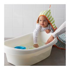 a baby in a bathtub with a hat on