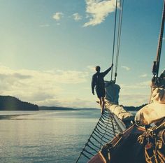 a man standing on the side of a boat