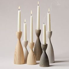 several wooden candlesticks lined up next to each other