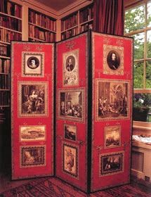 a room divider with pictures on it in front of a bookcase filled with books