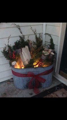 a bucket filled with candles sitting on top of a porch