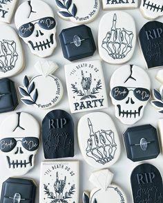 many decorated cookies with black and white designs on them are arranged in the shape of skulls