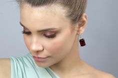 Make a statement with these gorgeous Rectangular Garnet Gold Dangle Earrings. Measuring 13x18mm, these earrings feature prong-set semiprecious garnet stones, making them a perfect accessory to celebrate your January birthstone. The gold finish adds a touch of luxury, making these earrings a great choice for special occasions. These handmade earrings are crafted with high-quality materials and are sure to last for years to come. January birthstone garnet earrings Prong set semiprecious stones Han Elegant Garnet Drop Earrings, Elegant Garnet Earrings, Elegant Garnet Gemstone Earrings, Garnet Gemstone Earrings, Elegant Rectangular Stone Earrings, Elegant Earrings With Rectangular Stone For Anniversary, Rectangular Earrings For Formal Occasions, Elegant Anniversary Earrings With Rectangular Stone, Elegant Garnet Earrings For Anniversary