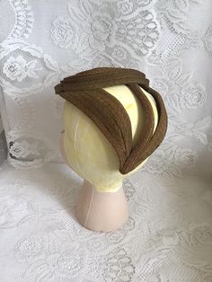 "Vintage 1930's 1940's Art Deco tilt style hat. Rare and unique style. The top of the hat is a swirled disc shape. Has a unique back to it. No makers label or tag. There is a small remnant inside the hat of paper that may have been a tag.  *SCROLL DOWN FOR CONDITION & MEASUREMENTS*  CONDITION: No issues noted. MEASURES: Inside circumference of swirled disc~17\" Disc front to back~5 1/2\" Disc left to right~6\" Length of 3 pieces in the back of the hat~Left one 7\"/Middle one 6\"/right one 7\" *WE APOLOGIZE~BUT WE NO LONGER SHIP TO GERMANY, ITALY OR SPAIN. IF ORDERS COME IN FROM GERMANY, ITALY OR SPAIN, WE WILL HAVE TO CANCEL THEM AND REFUND YOUR MONEY. I'M SORRY FOR THIS INCONVENIENCE*" Vintage Adjustable Fascinator With Structured Crown, Retro Fitted Cloche Hat, Vintage Fitted Wide Brim Cloche Hat, Fitted Retro Brown Cloche Hat, Fitted Wide Brim Vintage Cloche Hat, Vintage Wide Brim Fitted Cloche Hat, Vintage Kentucky Derby Fascinator With Structured Crown, Vintage Adjustable Costume Hats With Structured Crown, Vintage Fascinator For Kentucky Derby With Structured Crown