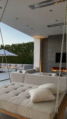 a living room filled with furniture and a fire place in the middle of an open floor plan