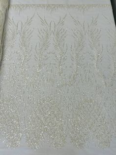 Beaded Fabric Available in Multiple Colors This fancy bead design includes embroidered heart and feather patterns with beads across a mesh fabric of great quality. The fabric is filled with beads giving it an elegant & luxurious look. This lace can be used for dresses, tablecloths, nightgowns, prom gowns, bridesmaid gowns, wedding gowns, table covers/runners, pillows, home /event decorations, and much more.If you purchase more than one yard we will send you the fabric in one piece. 100% Polyeste Dear Costume, Bridal Fabric, Fancy Beads, Beaded Wedding, Feather Pattern, Gowns Wedding, Embroidered Wedding, Embroidered Heart, Plant Pattern