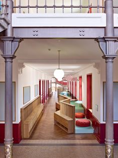 the hallway is lined with benches and tables for people to sit on or walk down