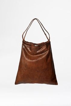 Minimalist drawstring bag in soft full-grain leather for everyday life. - Full grain leather - Cotton lining - 3 inside pockets - Weight: 0.35 kg - Width (opening): 31 cm - Width (base): 41 cm - Height: 42.5 cm - Drop length of shoulder strap (bag open): 20 cm - Drop length of shoulder strap (bag closed): 36 cm Textured Leather Bucket Bag Pouch For Everyday Use, Everyday Soft Leather Pouch Backpack, Leather Hobo Bag With Dust Bag For Everyday Use, Everyday Brown Textured Leather Backpack, Brown Soft Leather Daily Backpack, Everyday Soft Brown Leather Backpack, Daily Brown Soft Leather Backpack, Soft Leather Bucket Backpack For Daily Use, Everyday Brown Leather Pouch Backpack