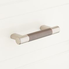 a close up of a door handle on a white wall