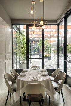 a dining room table is set with white linens