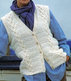 a woman wearing a white knitted vest and scarf