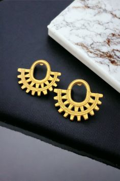 Finish your look with these stunning mini crescent earrings. They are a true standout.  Our Precolumbian pieces are inspired by the beautiful gold-work made by ancient indigenous civilizations that once lived in Colombia before the arrival of the Spaniards  in  1.492. Our Precolumbian pendants are replicas made of 24k gold plated, nickel free pewter, and will be embellished by semiprecious stones, ceramic beads, and natural materials. Crescent Earrings, Jewelry Statement, Gold Work, Ceramic Beads, Jewelry Earrings Studs, Natural Materials, Semiprecious Stones, Crescent, Statement Earrings