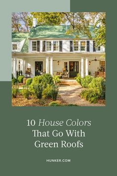 a white house with green roof and bushes in front of it, the words 10 house colors that go with green roofs