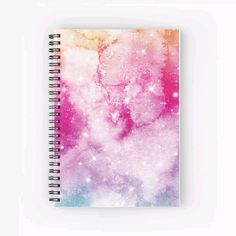 a spiral notebook with pink and blue stars on it