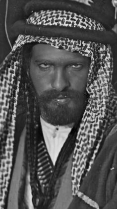 black and white photograph of a man wearing a headdress