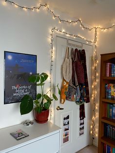 a room that has some lights on the wall and clothes hanging up in front of it