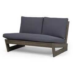 a gray couch with two pillows sitting on it's back legs and armrests