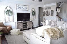 a living room filled with furniture and a flat screen tv