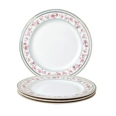 three plates with pink flowers on them and one white plate in the middle is empty