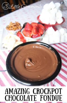 chocolate fondue with strawberries and marshmallows in the background text reads amazing crockpot chocolate fondue