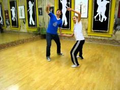 two people in a dance class practicing their moves