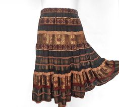 Vintage skirt with 3 layers of beautiful brocade-style fabric in bronze and brown. Elastic in the waist that can be stretched up to 96cm / 37.7 inches in circumference. Size L to XL. Very good condition. Length of the skirt is 78 cm / 30.7 in inches.  waist 82 cm / 32.3 in inches. P.S. Take in consideration that these clothes are not brand new. It's used so do not expect a perfect brand new condition. Support Zero Waste movement buying this item and extending it's life. Brown Lined Tiered Skirt, Brown Tiered Lined Skirt, Brown Ruffled Flared Skirt, Brown Gathered Long Skirt, Brown Long Gathered Skirt, Brown Long Skirt For Festival, Festival Long Brown Skirt, Bohemian Brown Flared Skirt, Brown Flowy Bohemian Skirt