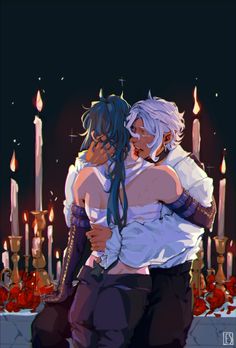 two people hugging in front of candles with one person holding the other's head