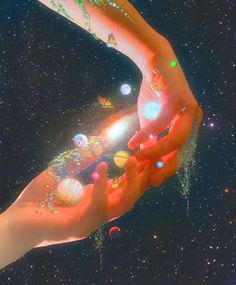 two hands reaching out towards each other in front of the stars and planets above them