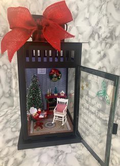 a miniature house with a christmas tree and decorations