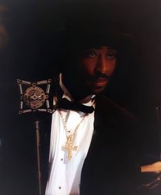 a man in a tuxedo with a cross on his lapel