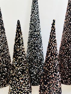 several black and white trees with gold dots on them