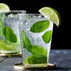 two glasses filled with mojito tea and lime