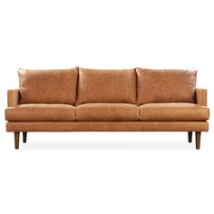 a tan leather couch sitting on top of a white floor