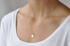 Our gift to you 10% off your first purchase. Details here - http:/eepurl.com/dpVPBzOur dainty sun necklace in gold or silver is sure to brighten your day. This sun pendant necklace moves freely on a delicate but sturdy chain. Wear this tiny sun charm as a layering piece or alone as a simple statement necklace......................DETAILSNecklace features a 1/2" 24 k gold plate or sterling silver sun charm pendant14 k gold fill or sterling silver chain dainty but sturdy chainThis listing is for o Simple Statement Necklace, Necklace Sun, Sun Charm, Sun Necklace, Sun Pendant, Detailed Necklace, Gold Sun, Necklace Gold, Sterling Silver Chains